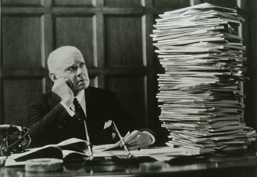 ibm.man_looking_at_stack_of_papers.102649709.lg